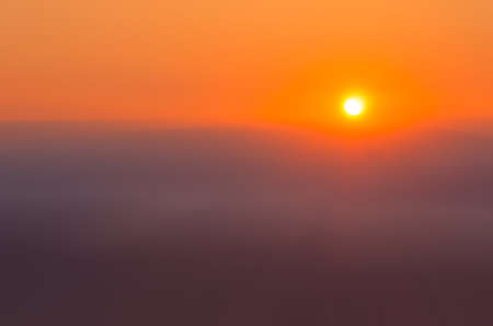 blood foggy sunrise over the mountainsの写真素材