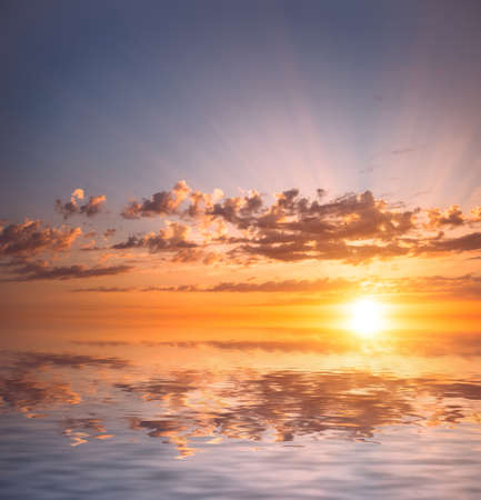 Very beautiful sea sunset with red clouds and the rays of the sun. Natural dawn composition