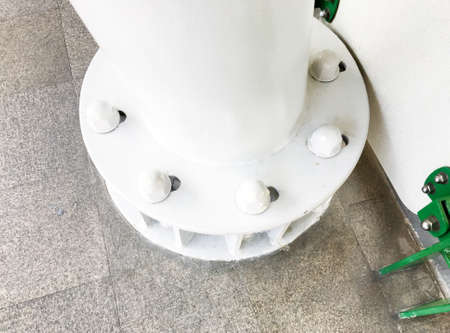 Larger screws into the base of a metal pillar.の写真素材