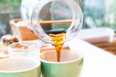Blur image Tea being poured into tea cup at sunlight.の写真素材