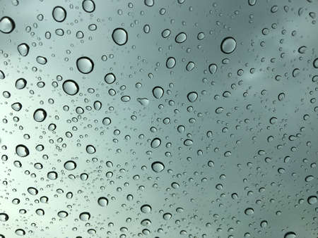 Rain drop on car glass abstract background, Green tone.の写真素材