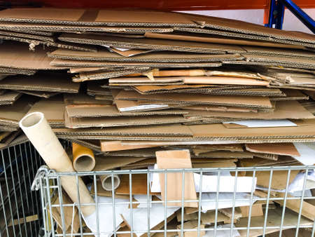 Cardboard boxes in a steel grate, Folded cardboard box.の写真素材
