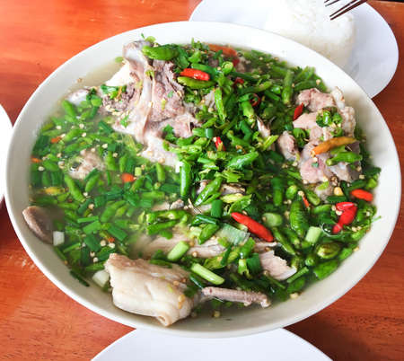 Close up pork bone boiled with lemon and spicy chili on wood table background, Super Leng Saab,...