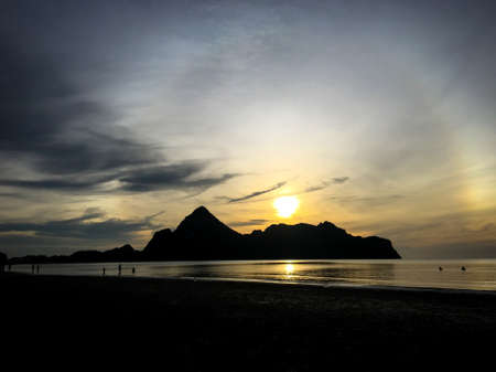 The beautiful nature sunset on the sea with mountain.の写真素材