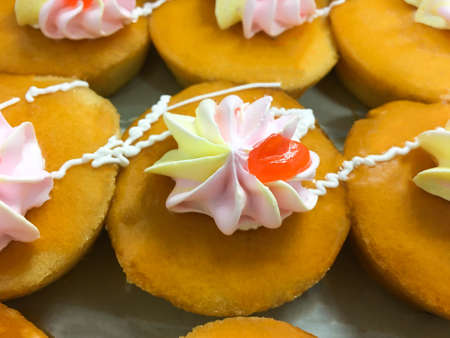 Close up top view butter soft cake with cream and orange jam.
