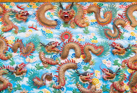 Dragon statue of wall background texture, Chinese golden dragon.の写真素材