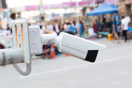 Closed circuit television camera on blurred market background texture.の写真素材