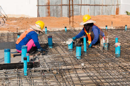 Construction worker is steel wire tie working at outdoor.の写真素材