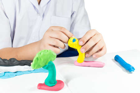 little hand playing with colorful clay isolate on white background texture.の写真素材