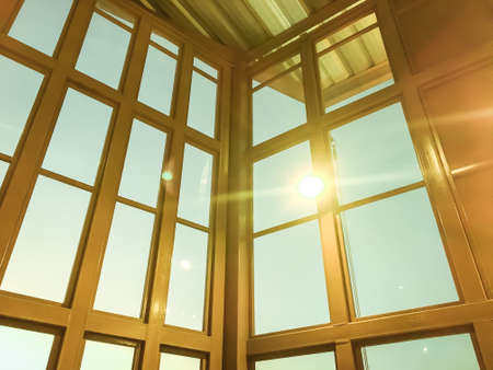 Golden window in department store with sky and sun abstract background texture.の写真素材