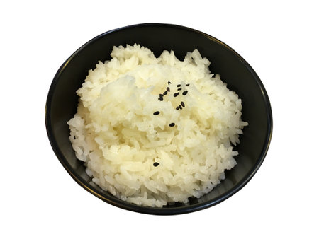 Top view of Japanese rice sprinkled with black sesame seeds in black bowl isolated on white background. Japanese food style. Clipping path.の写真素材