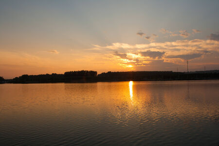 Sunset in a calm lakeの写真素材