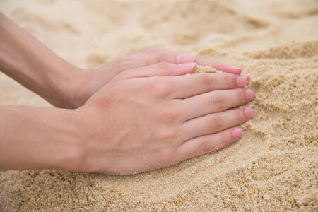Hands forming a cone in sandの写真素材