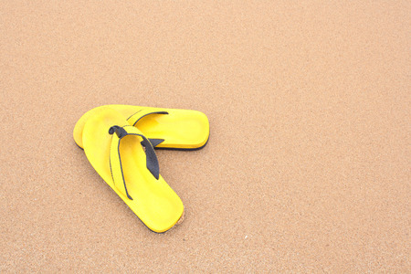 Yellow slippers on beach