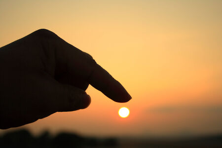 Fingers on sunsetの写真素材