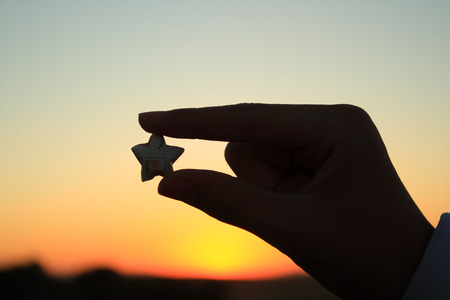 Holding an star shaped silhouetteの写真素材