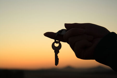 Holding an key silhouetteの写真素材