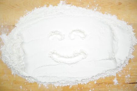 Smiley face on a cutting boardの写真素材