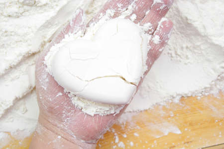 Heart shape flour in hand