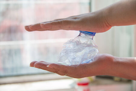 Hand squash a plastic bottle