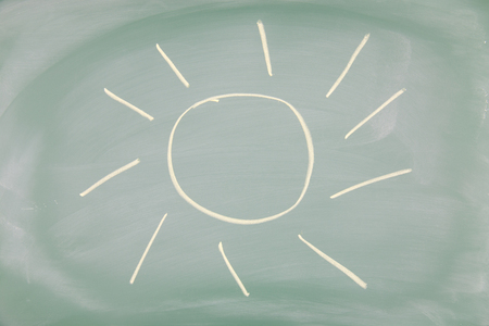 Sun drawn on a blackboardの写真素材