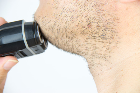 Shaving with an electric razorの写真素材