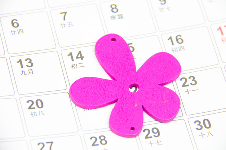 Pink flower laying on calendar pageの写真素材