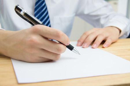 Businessman signing documents in the officeの写真素材