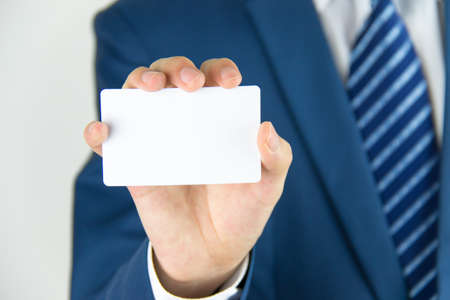 Man hand holding a business cardの写真素材