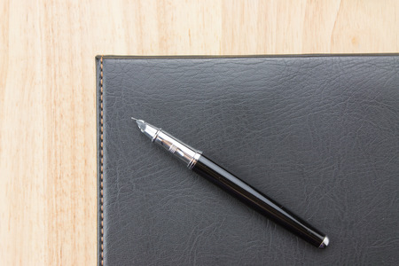Fountain pen in a notebookの写真素材