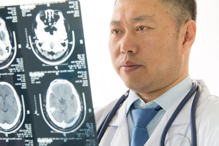 Asian male doctors radiologist studying patient's x-ray