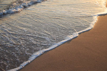 Sea wave over sand beachの写真素材