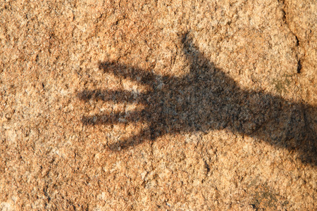 Hand shadow on stoneの写真素材