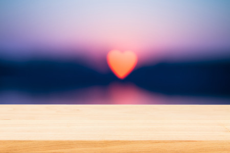 Empty wooden table over sun bokeh backgroundの写真素材
