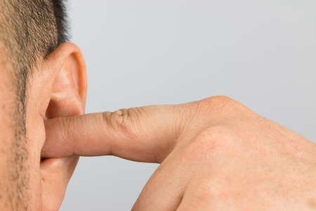 Man cover your ears with your fingers