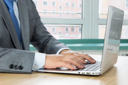 Businessman using laptop at workの写真素材