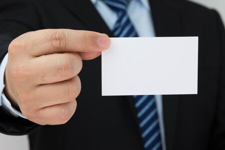Man hand holding a business card