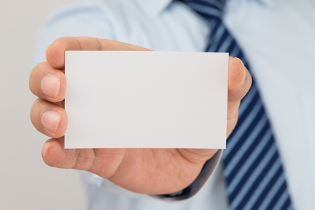 Man hand holding a business cardの写真素材