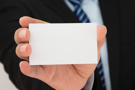 Man hand holding a business cardの写真素材