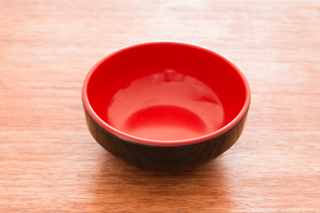 Empty bowl on a wooden boardの写真素材