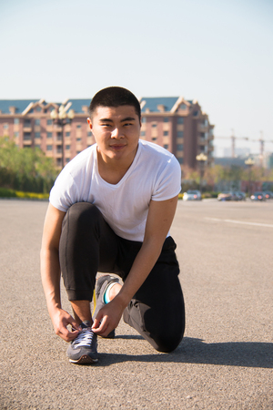 close up man runner tying shoelacesの写真素材