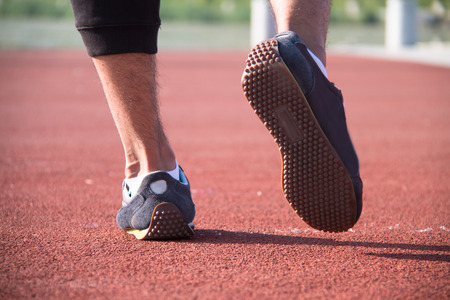 Closeup of a runner feet running on the road