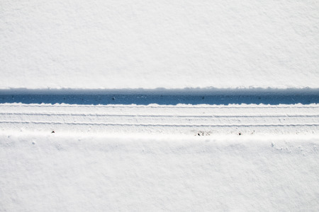 Car tire track on snowの写真素材