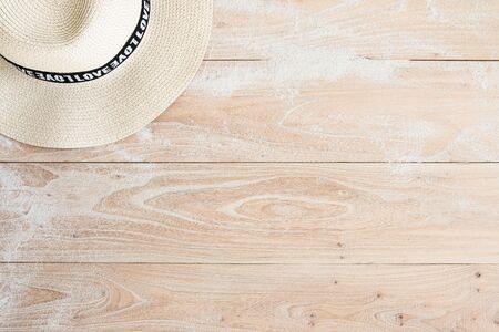 Straw hat on woodの写真素材