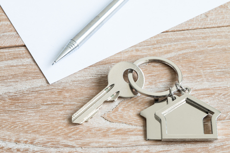 House shape keys and pen on a wooden backgroundの写真素材