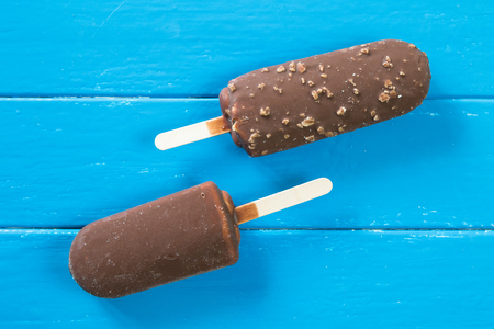 Chocolate ice pops in Blue wooden backgroundの写真素材