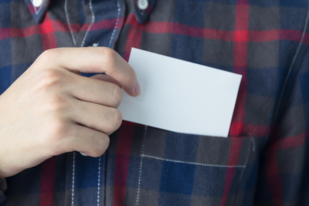 Young man holding a business cardの写真素材