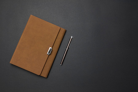 Notebook and pen on the deskの写真素材