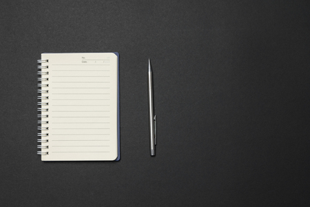 Notebook and pen on the deskの写真素材