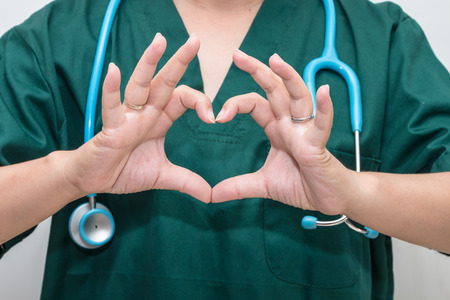 Doctor's hands forming a heart shapeの写真素材